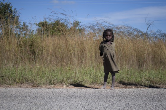 African Child waiting on the road,