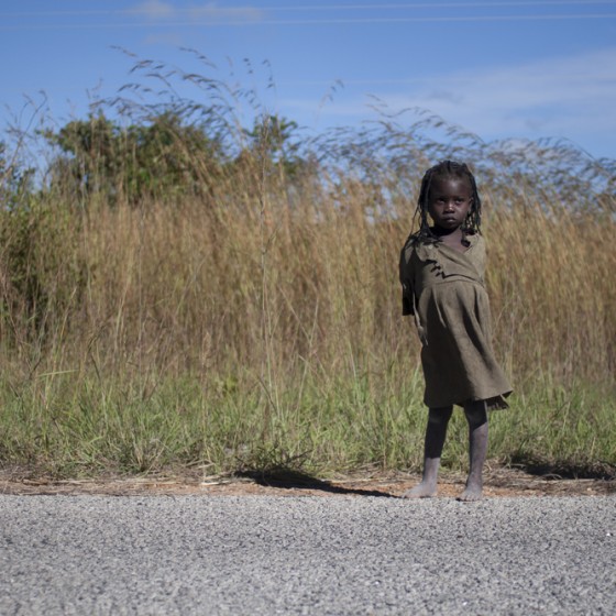 African Child waiting on the road,